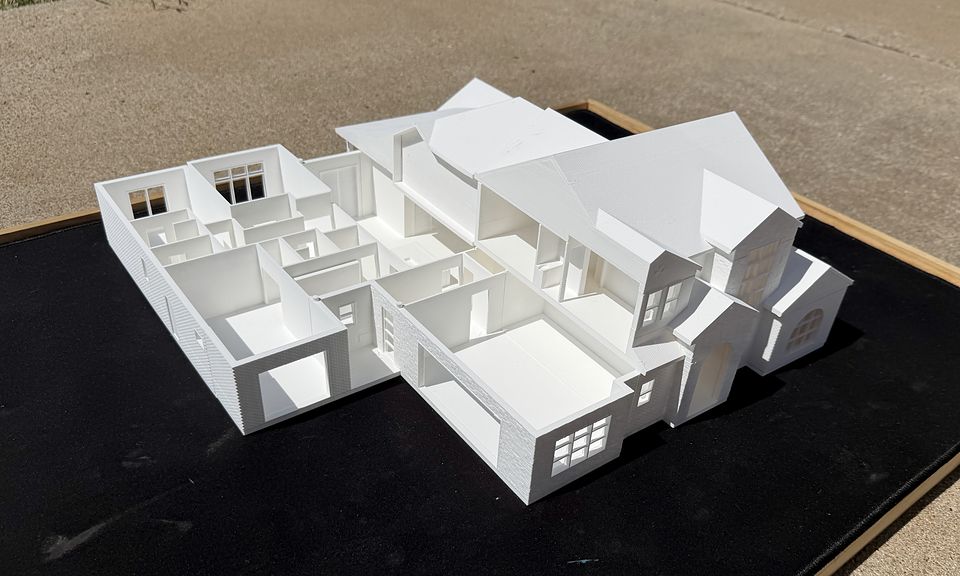 The Adeline model with the roof lifted off one wing, showing the rooms inside next to the roofed two-story section