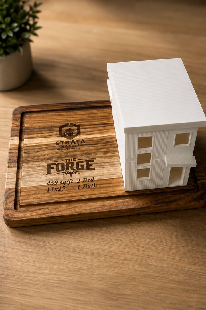 Digital rendering of The Forge from a front corner, on a wood base engraved with the Strata Models logo